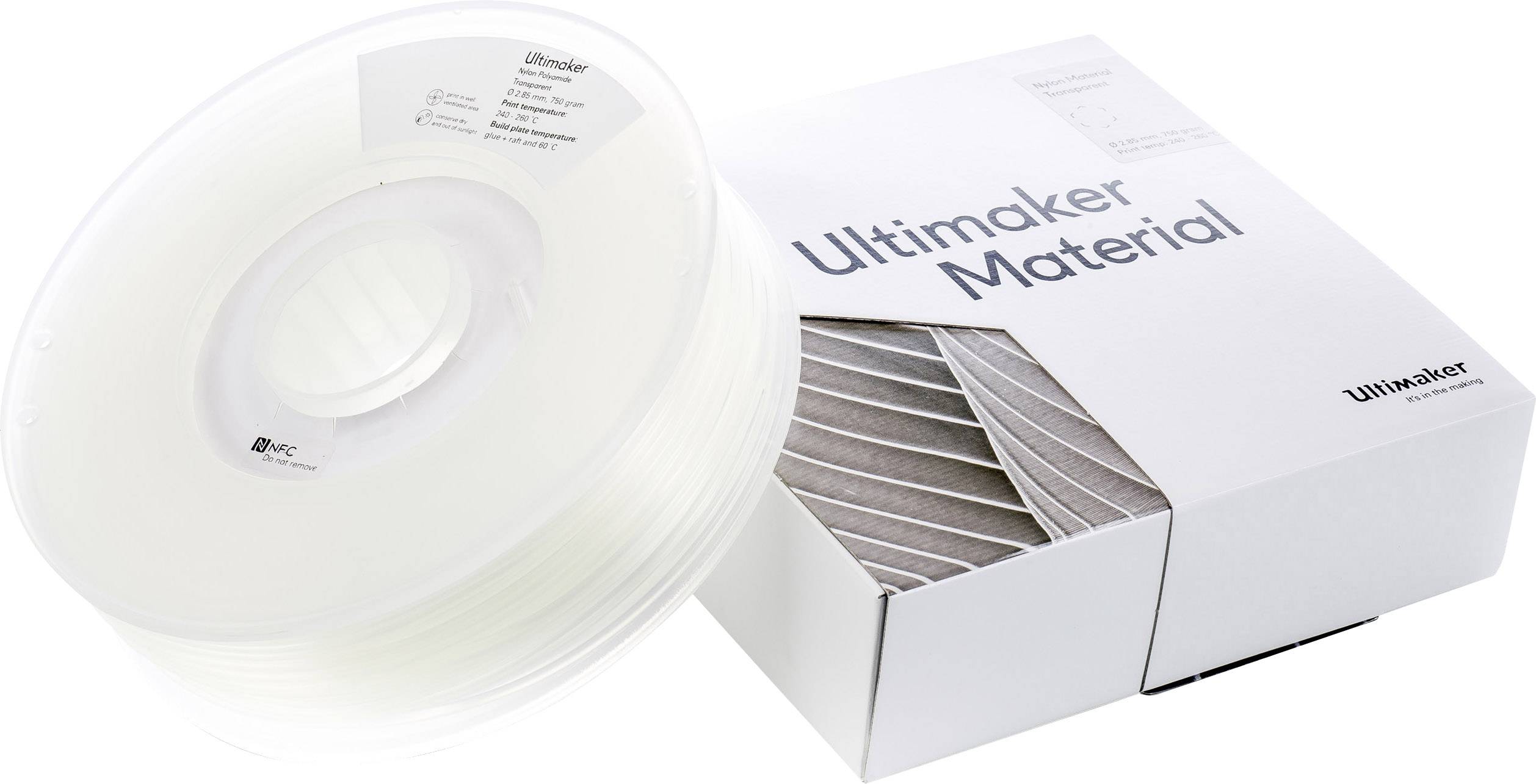 Rolka przezroczystego filamentu Ultimaker obok opakowania z napisem 'Materiał Ultimaker'. Odpowiedni do druku 3D.