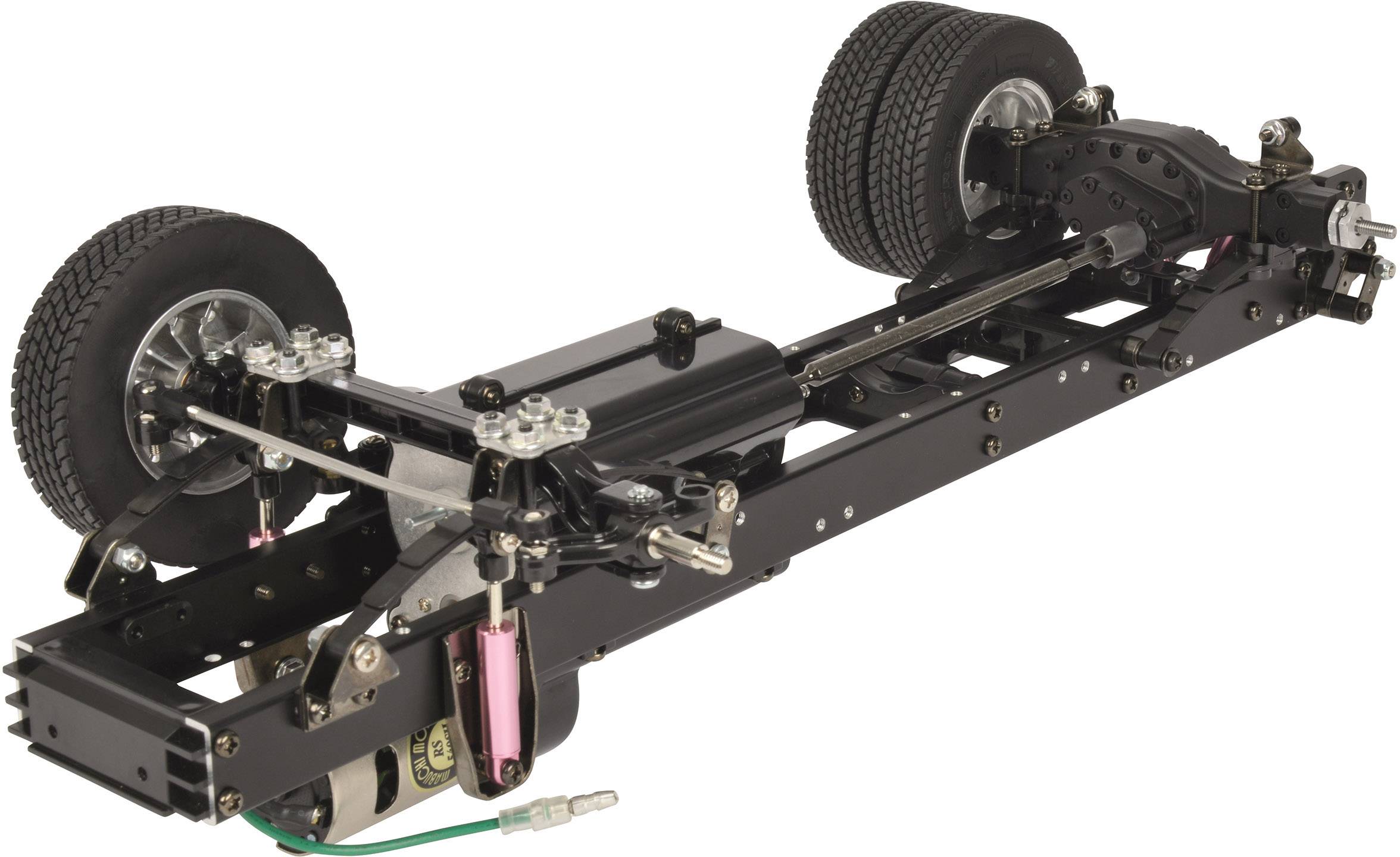 Model vehicle chassis with exposed frame, two axles, and mounted tires. Visible suspension and drive components.