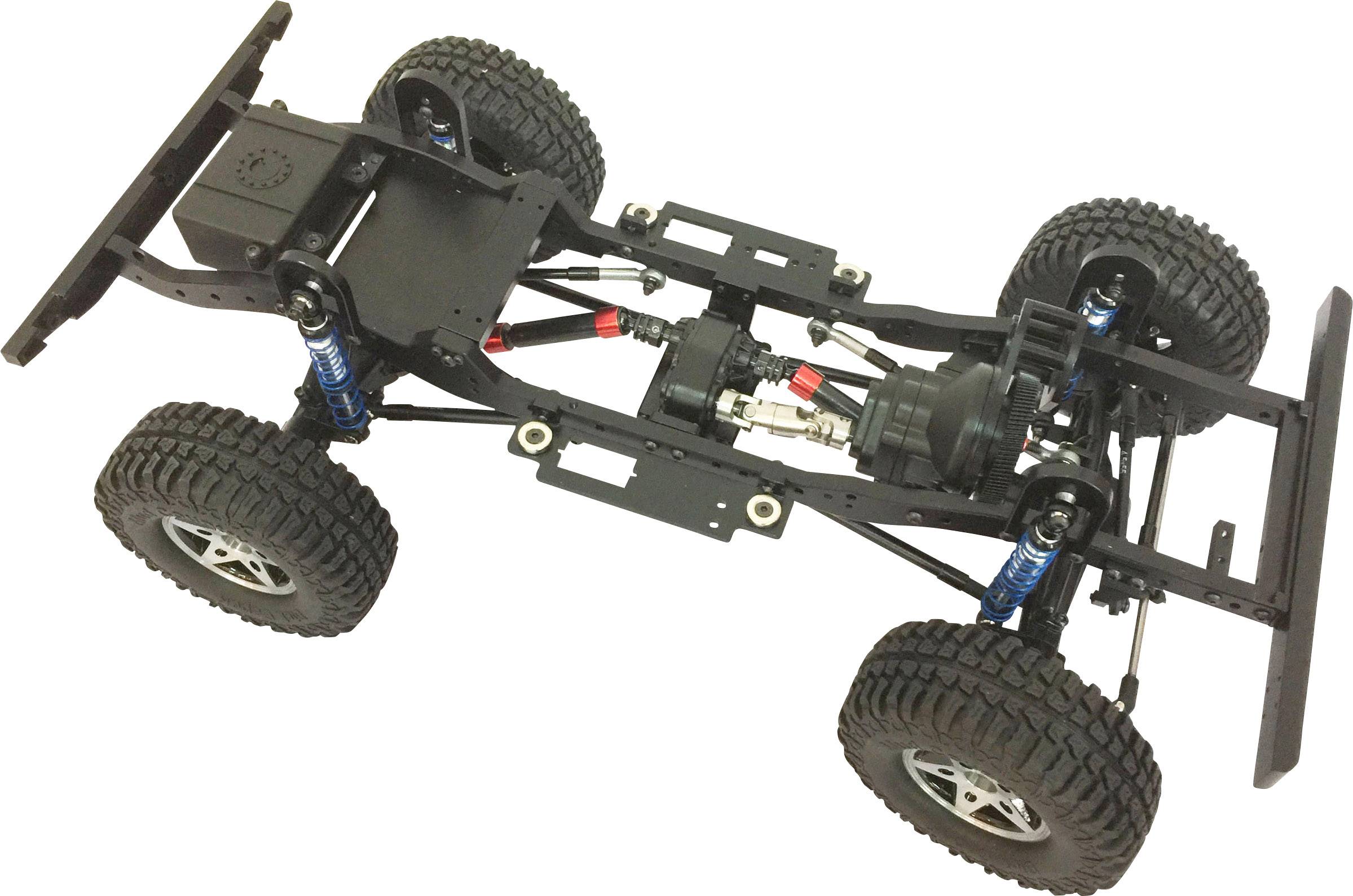 Widok zdalnie sterowanego podwozia pojazdu terenowego z czterema dużymi oponami, widocznym amortyzatorem, silnikiem i konstrukcją osi.