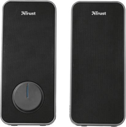 Dwa czarne głośniki z srebrną obwódką, jeden z dużym regulatorem głośności. Widoczna nazwa marki 'Trust' u góry.