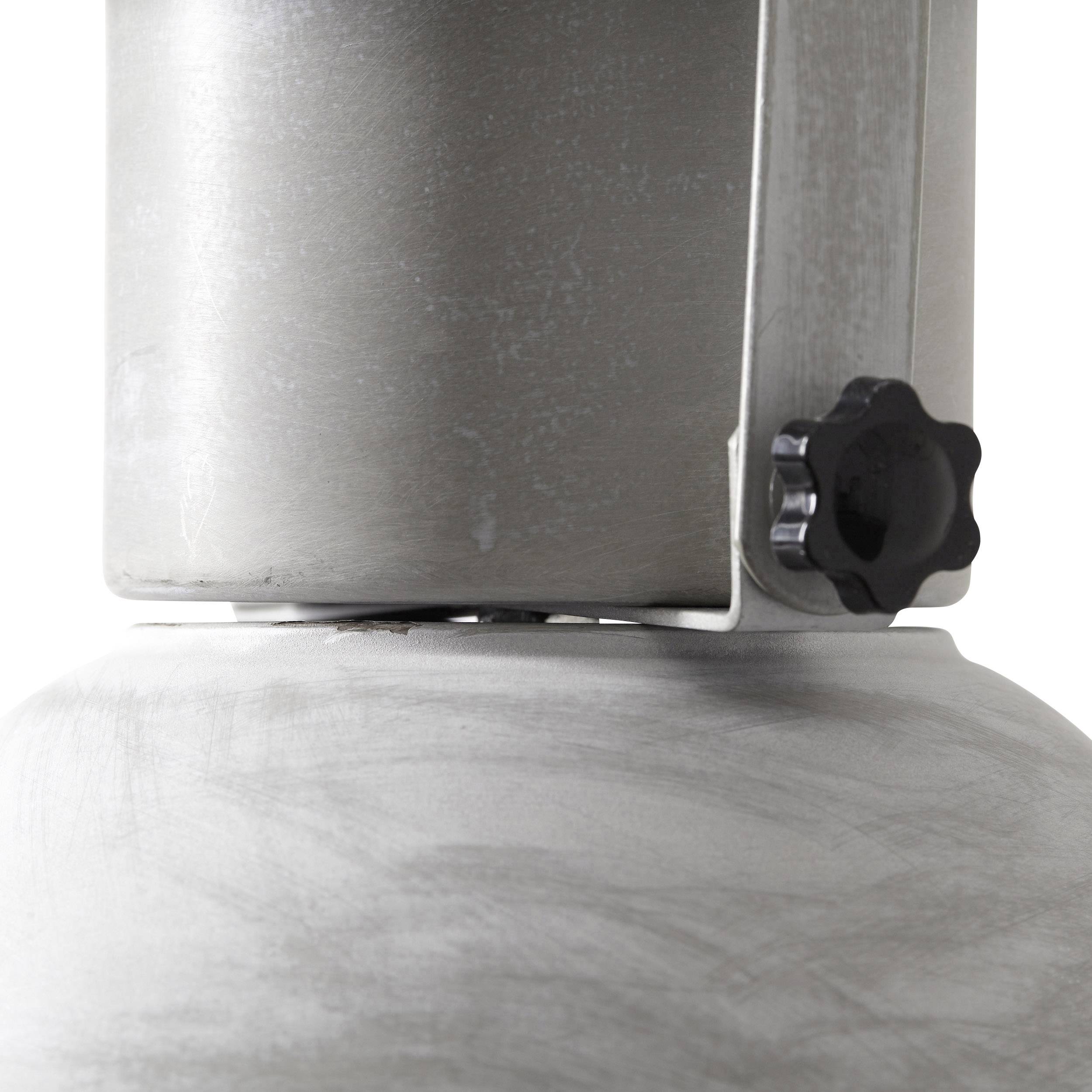 Zbliżenie urządzenia metalowego z pokrętłem z boku, prawdopodobnie sprzęt techniczny lub przemysłowy.