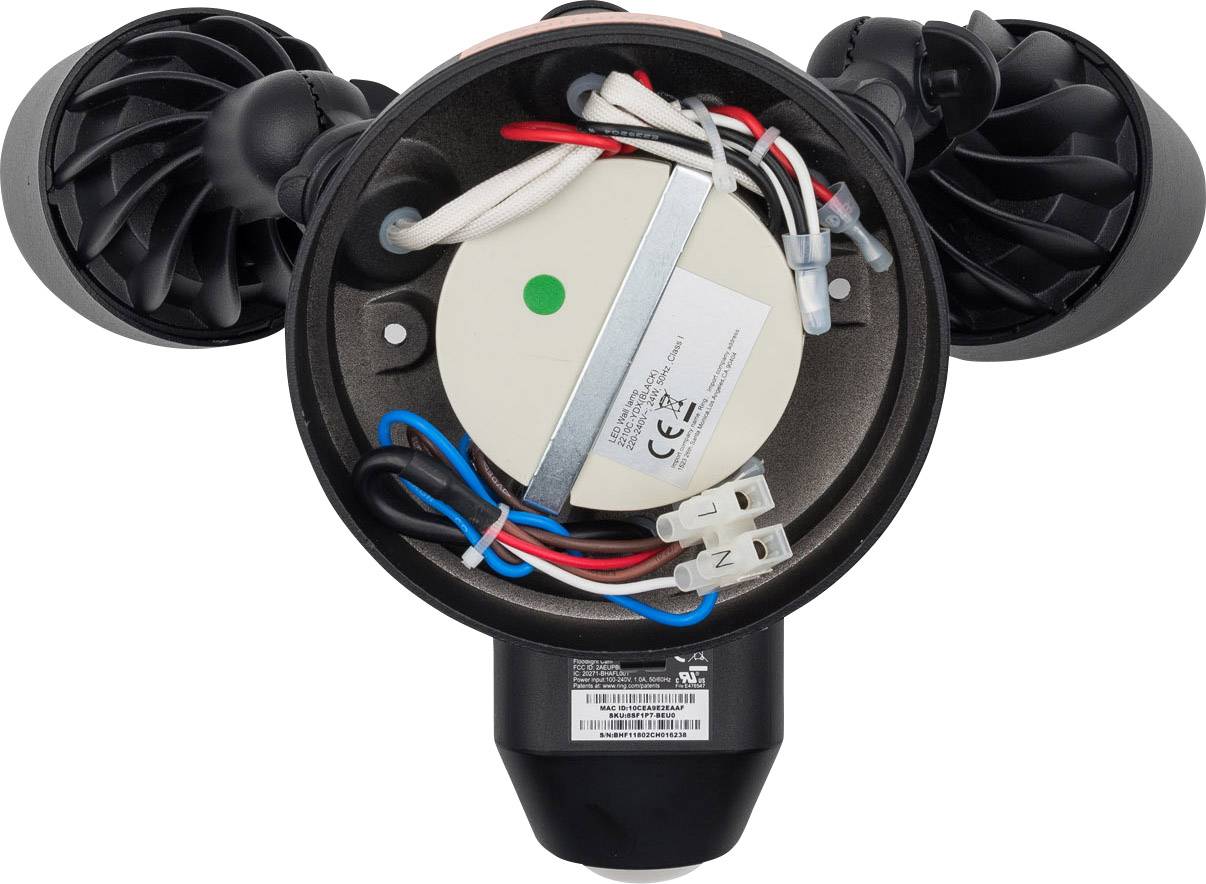 Otwarzona obudowa urządzenia technicznego ukazuje szczegółowe okablowanie i komponenty elektroniczne, w tym czerwone, niebieskie i białe przewody.