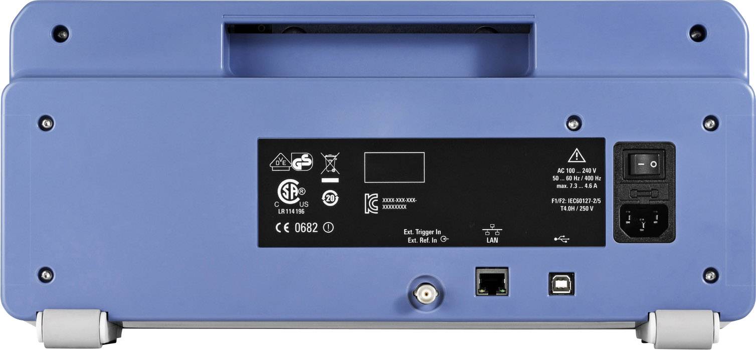 Tylna strona niebieskiego urządzenia elektronicznego z różnymi złączami, przełącznikami i symbolami bezpieczeństwa. Po lewej stronie wskaźnik LED.