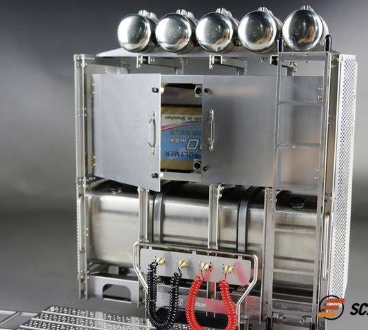 Metalowy sprzęt kuchenny z pięcioma kulistymi pojemnikami na górze; dwie szafkowe drzwiczki otwarte, przewód z przodu.