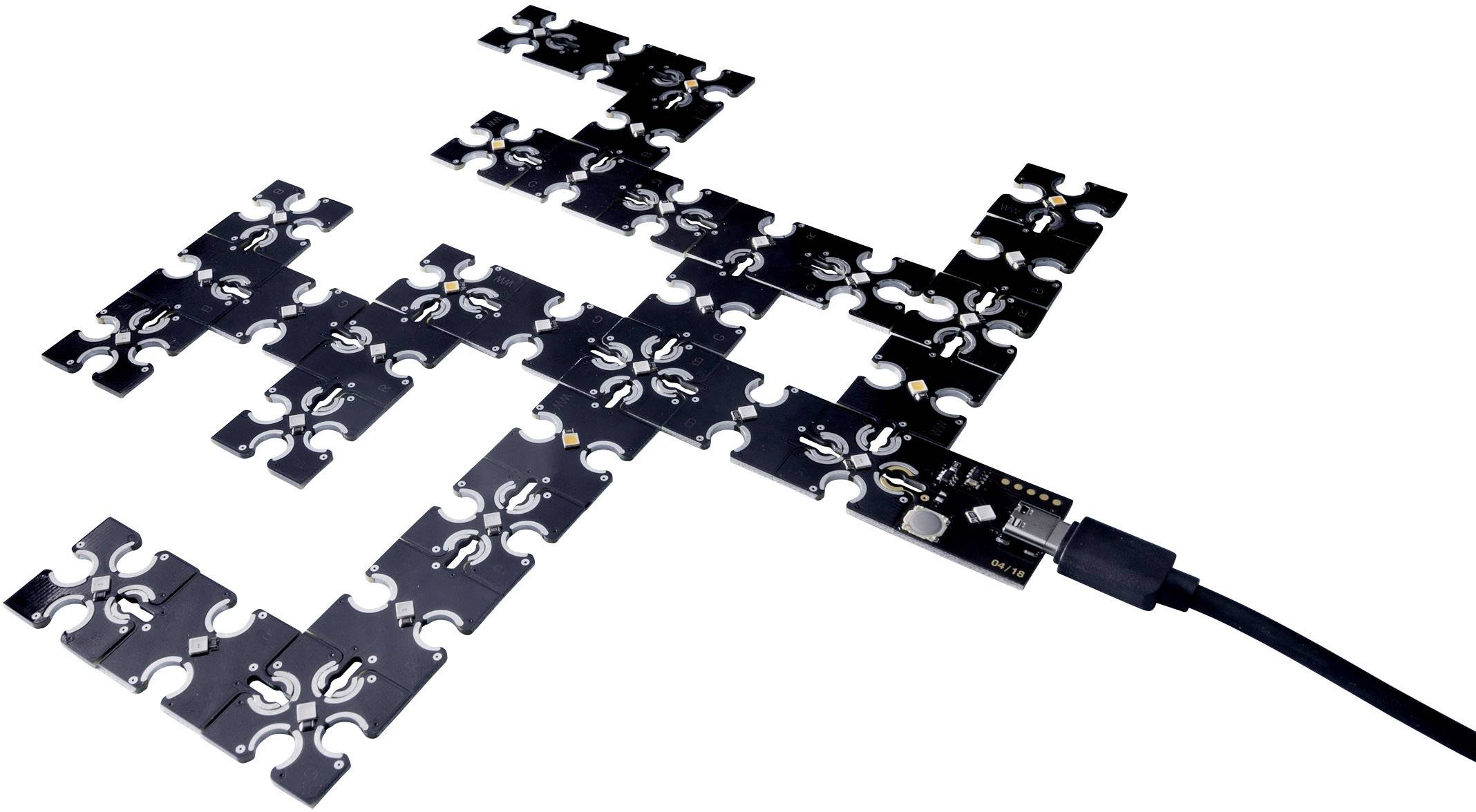 Modularny elektroniczny zestaw obwodów składający się z czarnych, prostokątnych elementów połączonych kablem USB.