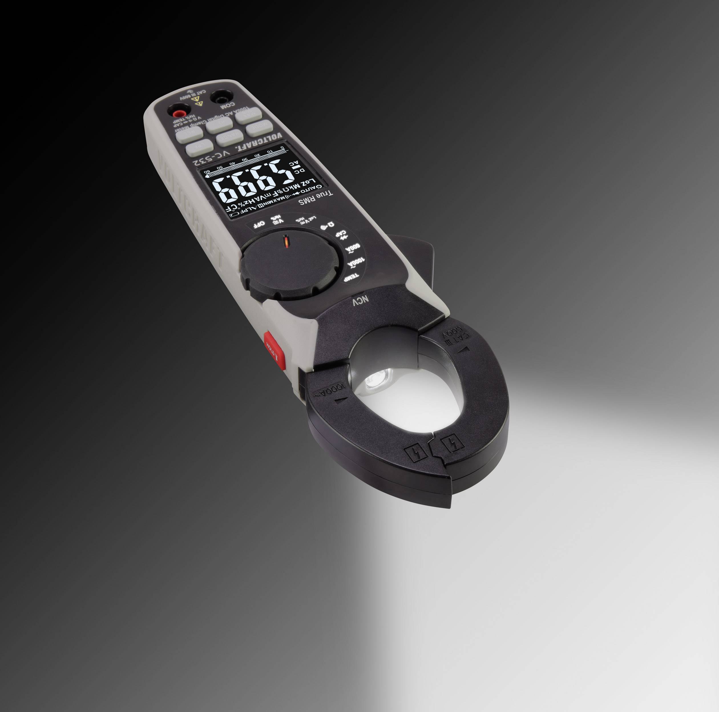 'Multimetr z funkcją cęgową na szarym tle. Pokazuje pomiar prądu z wyświetlaczem i pokrętłem regulacyjnym.'