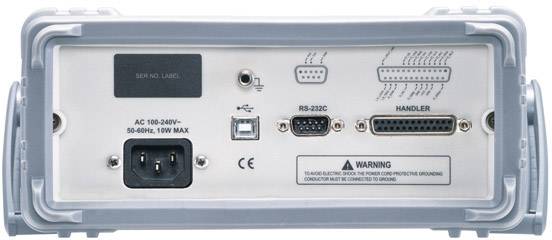 Tylna strona urządzenia elektronicznego z wieloma złączami, w tym złączem zasilania, USB, RS-232C oraz złączem handlerowym.