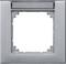 Szary, kwadratowy ramka maskująca z prostokątnym polem widzenia na górze, odpowiednia do włączników światła lub gniazd elektrycznych.