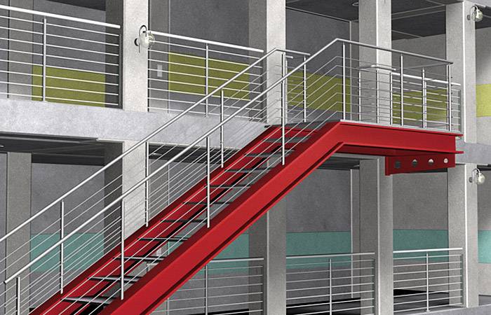 Klatka schodowa z szarego betonu z rzucającymi się w oczy czerwonymi schodami i metalowymi poręczami, nowoczesny design przemysłowy, wielopoziomowa.