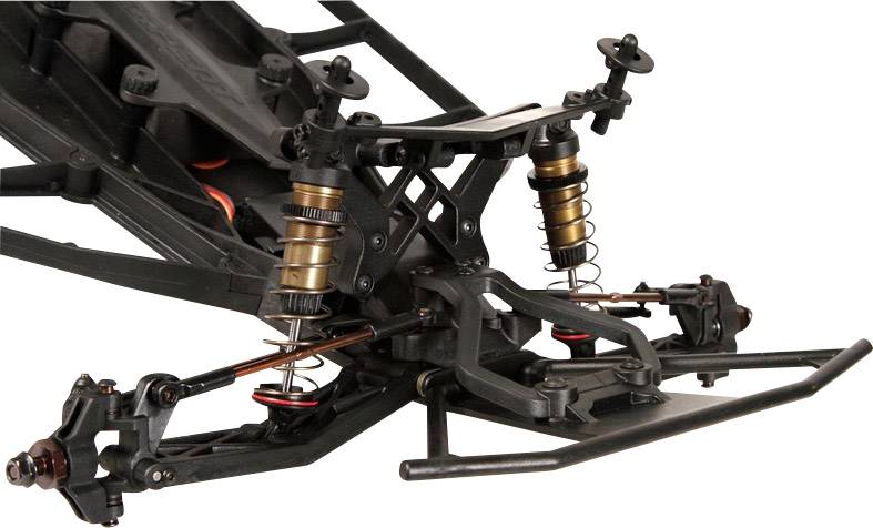 Zbliżenie systemu zawieszenia samochodu sterowanego zdalnie, ukazujące widoczne amortyzatory i wahacze, prezentujące szczegóły mechaniczne.