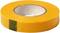 Rolka żółtej taśmy klejącej z szarą strefą klejącą pośrodku, leżąca na białej powierzchni.