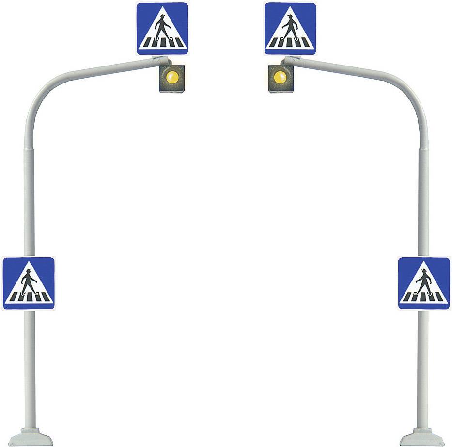 Dwie sygnalizacje świetlne z żółtym światłem i znakami przejścia dla pieszych wskazują na przejście dla pieszych.