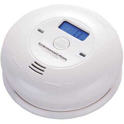 Okrągły czujnik tlenku węgla z wyświetlaczem cyfrowym, który pokazuje '70 ppm'. Posiada przyciski do testowania i resetowania.
