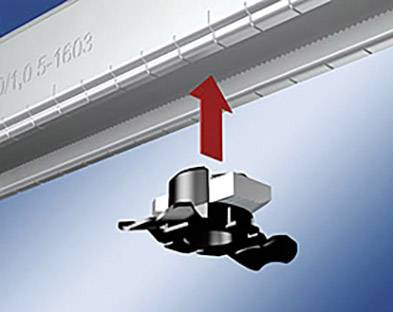 Czarne urządzenie przesuwa się w górę, co wskazuje czerwony strzałka. Znajduje się ono pod szarą, oznaczoną skalą listwą.