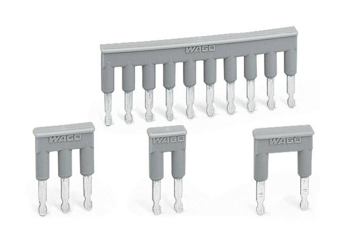 Szare mostki zaciskowe WAGO w różnych rozmiarach, stosowane do elektrycznego łączenia zacisków w instalacjach szeregowych.