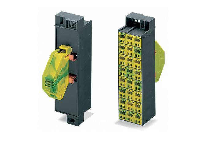 Dwa czarne moduły elektroniczne z zielonymi i żółtymi złączami. Po lewej: moduł modularny z zielono-żółtą dźwignią. Po prawej: kilka gniazd.