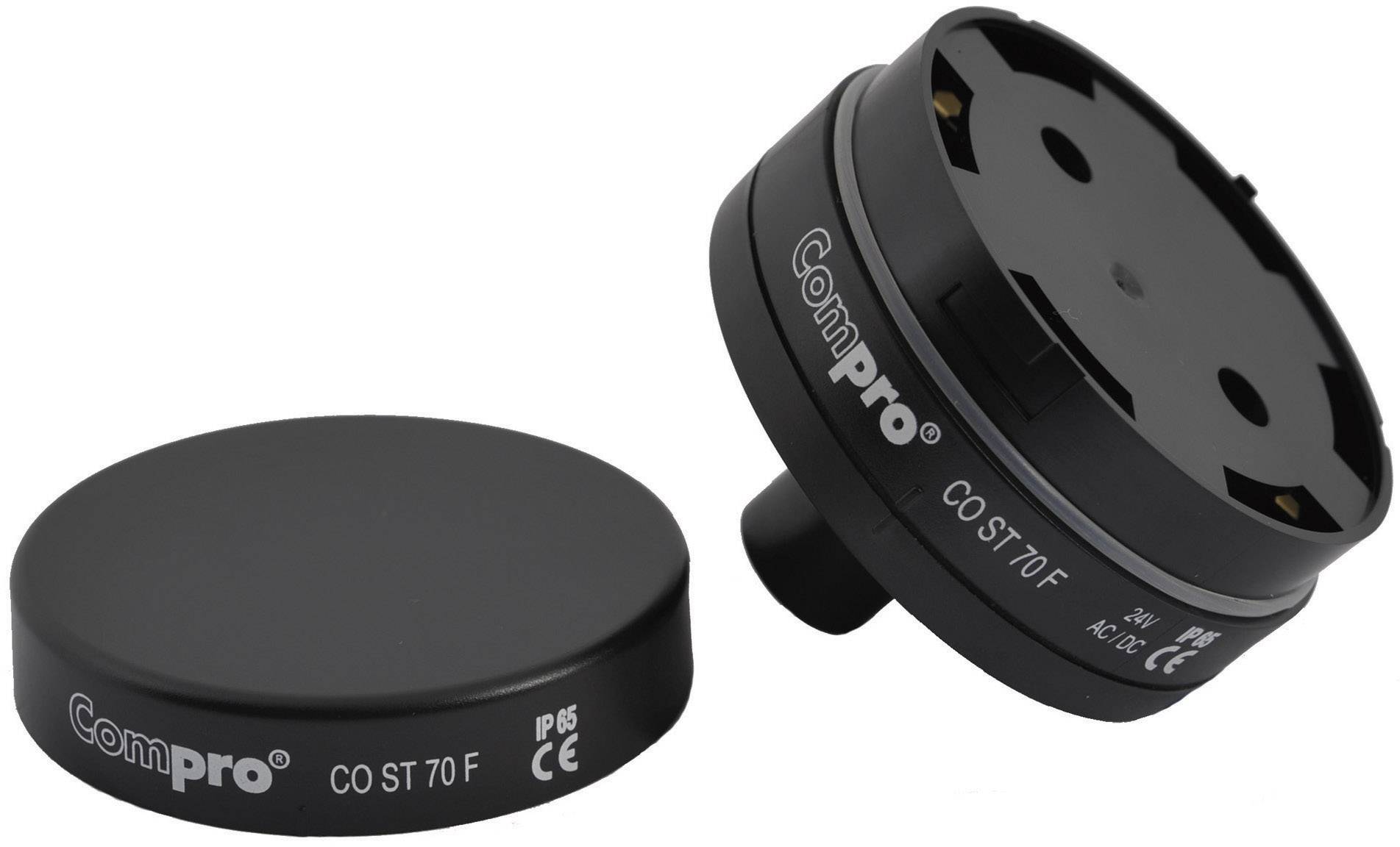 Dwa czarne urządzenia elektroniczne z napisem 'ComPro CO ST 70 F'. Jedno leży płasko, drugie jest widoczne od spodu.