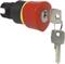 Czerwony wyłącznik awaryjny z dwoma włożonymi kluczami. Przełącznik jest cylindryczny, głównie czarny, z żółtym pierścieniem.