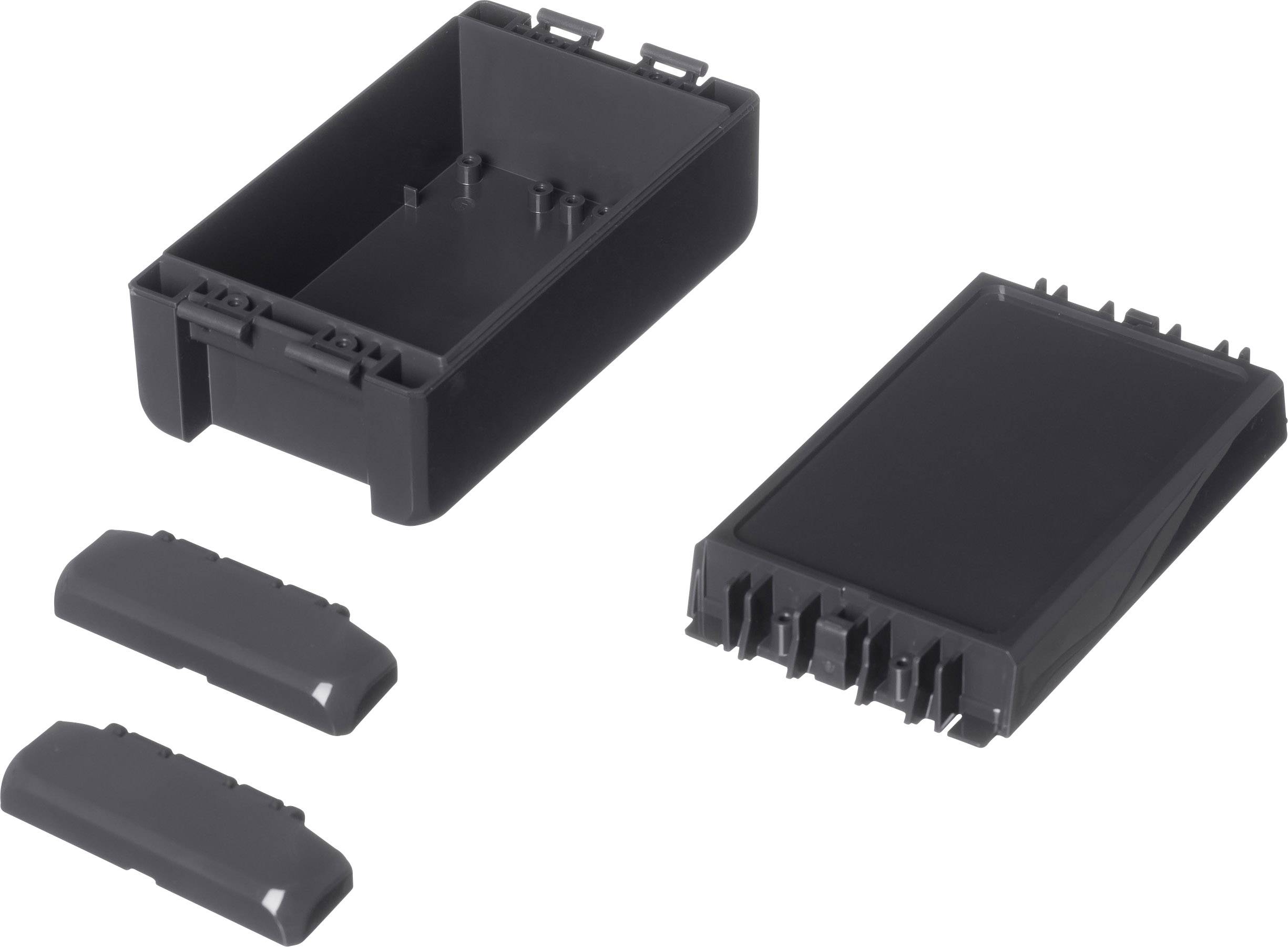 Czarna obudowa z tworzywa sztucznego, prostokątna, rozkładana na dwie główne części i dwie pokrywy. Połówki obudowy posiadają zatrzaski wciskowe.