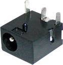 Czarna, prostokątna wtyczka DC z trzema metalowymi stykami. Służy do podłączenia kabla zasilającego urządzenie.