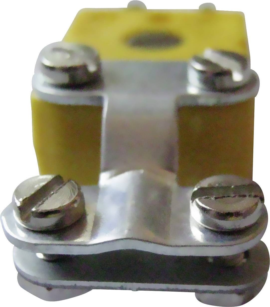 Metalowy obiekt z śrubami na żółtym tle. Wydaje się być częścią złącza technicznego lub elektrycznego.