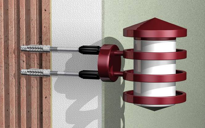 Czerwony kotwiczny element elewacyjny mocuje balustradę balkonu do ściany za pomocą śrub. Odpowiedni do konstrukcji betonowych i murowanych.