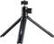 Czarny statyw stołowy z trzema rozkładanymi nogami i uchwytem na kamerę na górze. Odpowiedni do stabilnych ujęć kamerowych na płaskich powierzchniach.