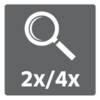 Symbol powiększenia z napisem '2x/4x', wskazujący na możliwość regulacji poziomu powiększenia.