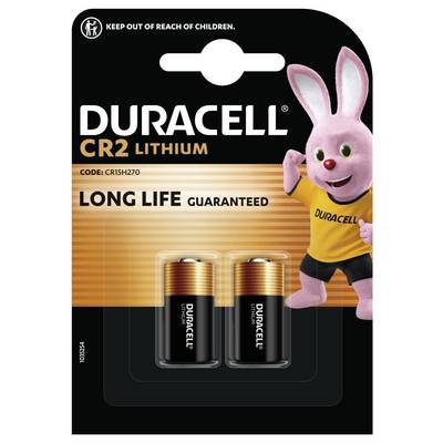 Balenie s dvoma líthiovými batériami Duracell CR2 s ružovým maskotom držiacim batériu. Text: „Dlhá životnosť garantovaná".