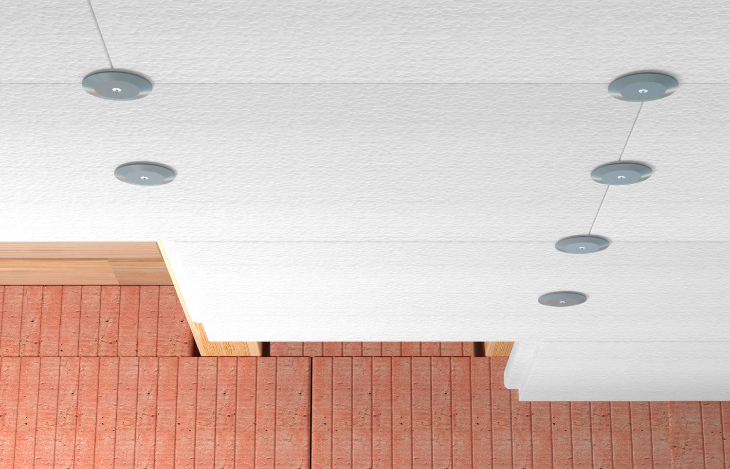 Minimalistický interiérový pohľad na biely strop s okrúhlymi zapustenými svetlami nad tehlovou stenou s architektonickým detailom.