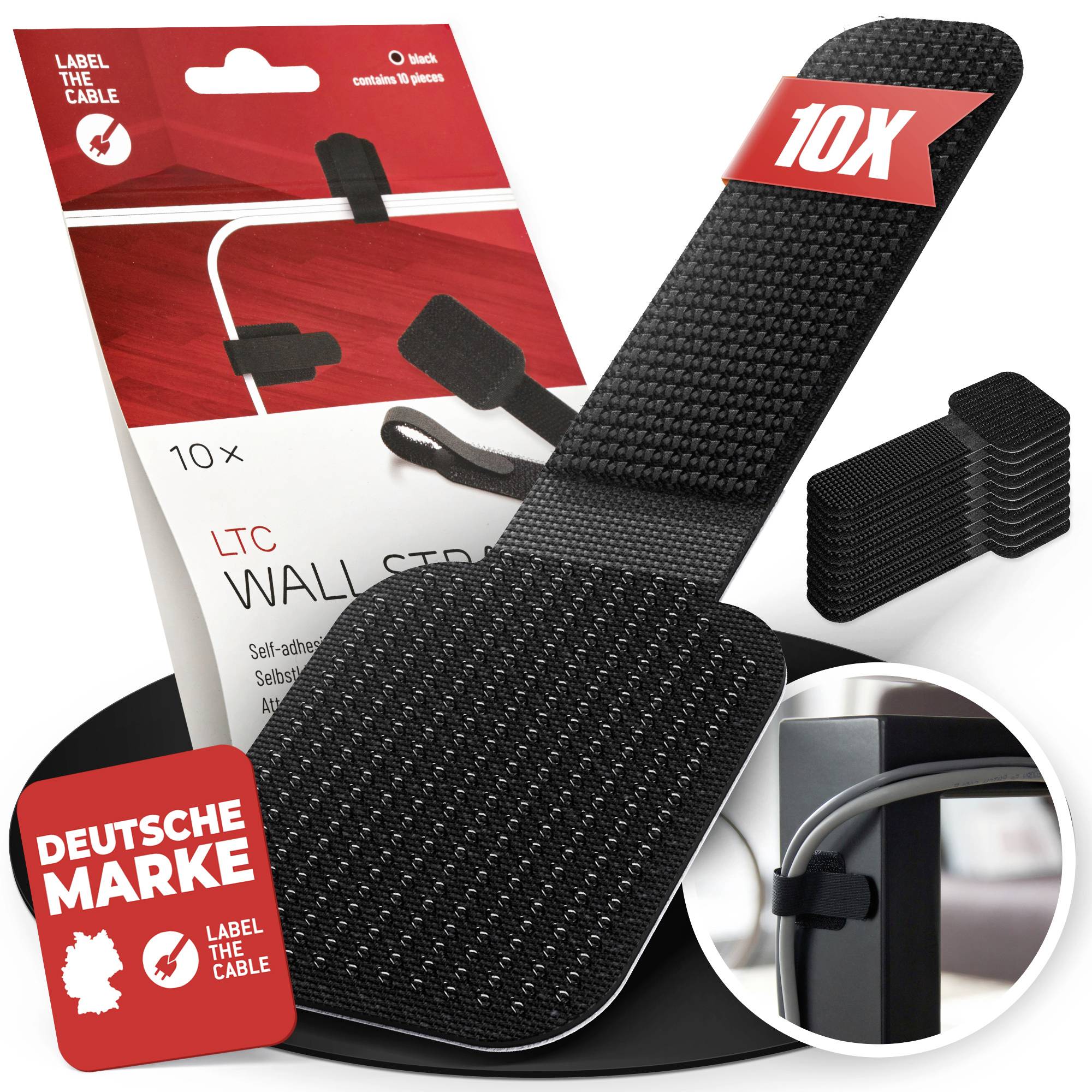 Balenie produktu pre „Label the Cable" 10x čierne samolepiace sťahovacie pásky na káble, s detailným zoomom ukazujúcim pásku upevňujúcu káble na stojan monitora.