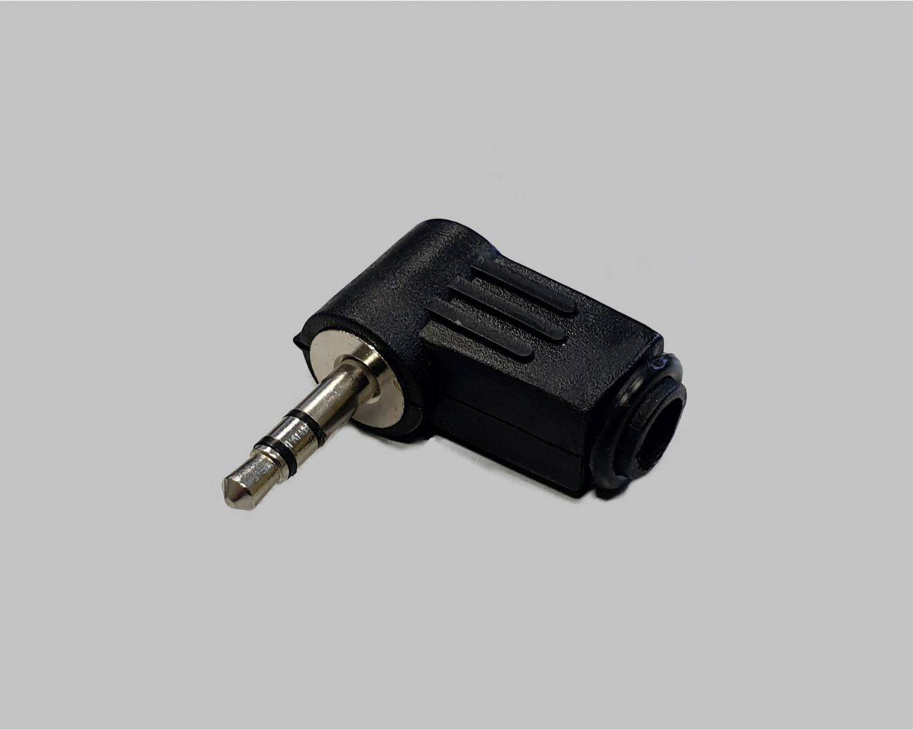 Čierny 3,5 mm audio adaptér v tvare obdĺžnika na sivom pozadí. Použitie: prepojenie audio káblov s rôznymi konektormi.