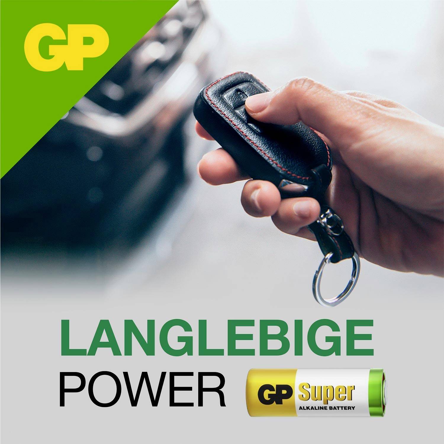 Ruka drží kľúč od auta vedľa rozmazaného auta; reklamná grafika s logom GP, text „Dlhodobá výdrž" a batéria „GP Super Alkaline Battery".