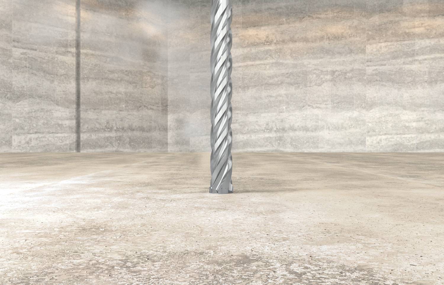 Kovová špirálová vrták alebo vrták stojí zvisle v prázdnej priemyselnej miestnosti so betónovými stenami.