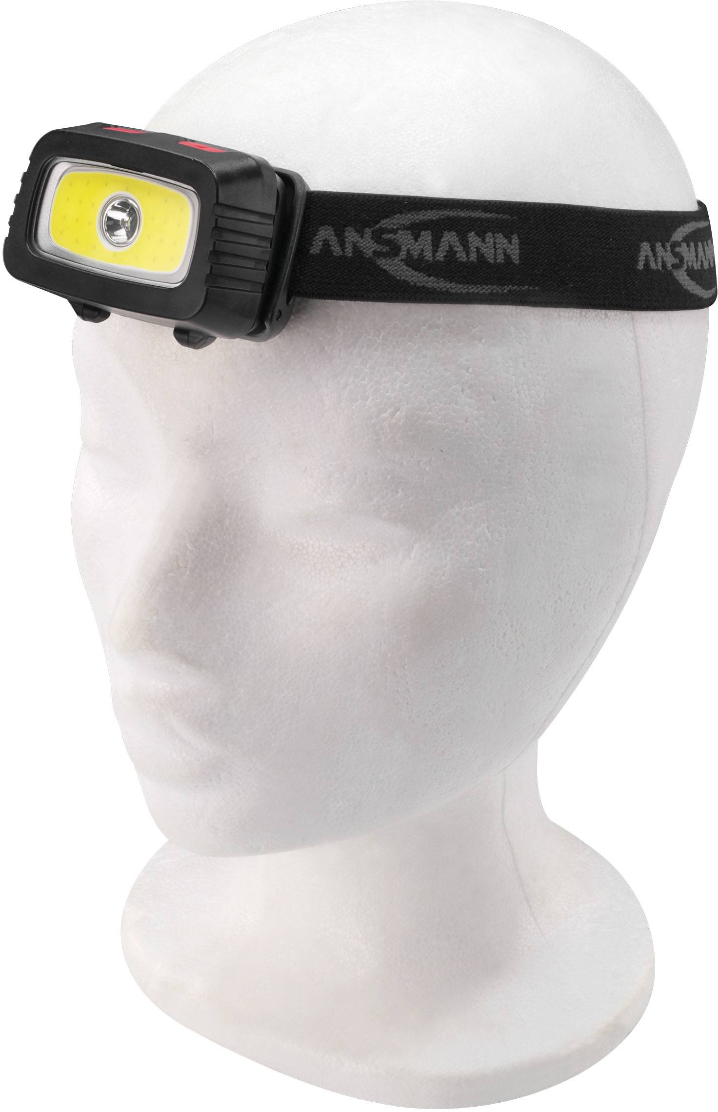 Čelová lampa na figuríne hlavy. Čierny pásik so žltým LED svetlom. Vhodná pre outdoorové aktivity v tme.