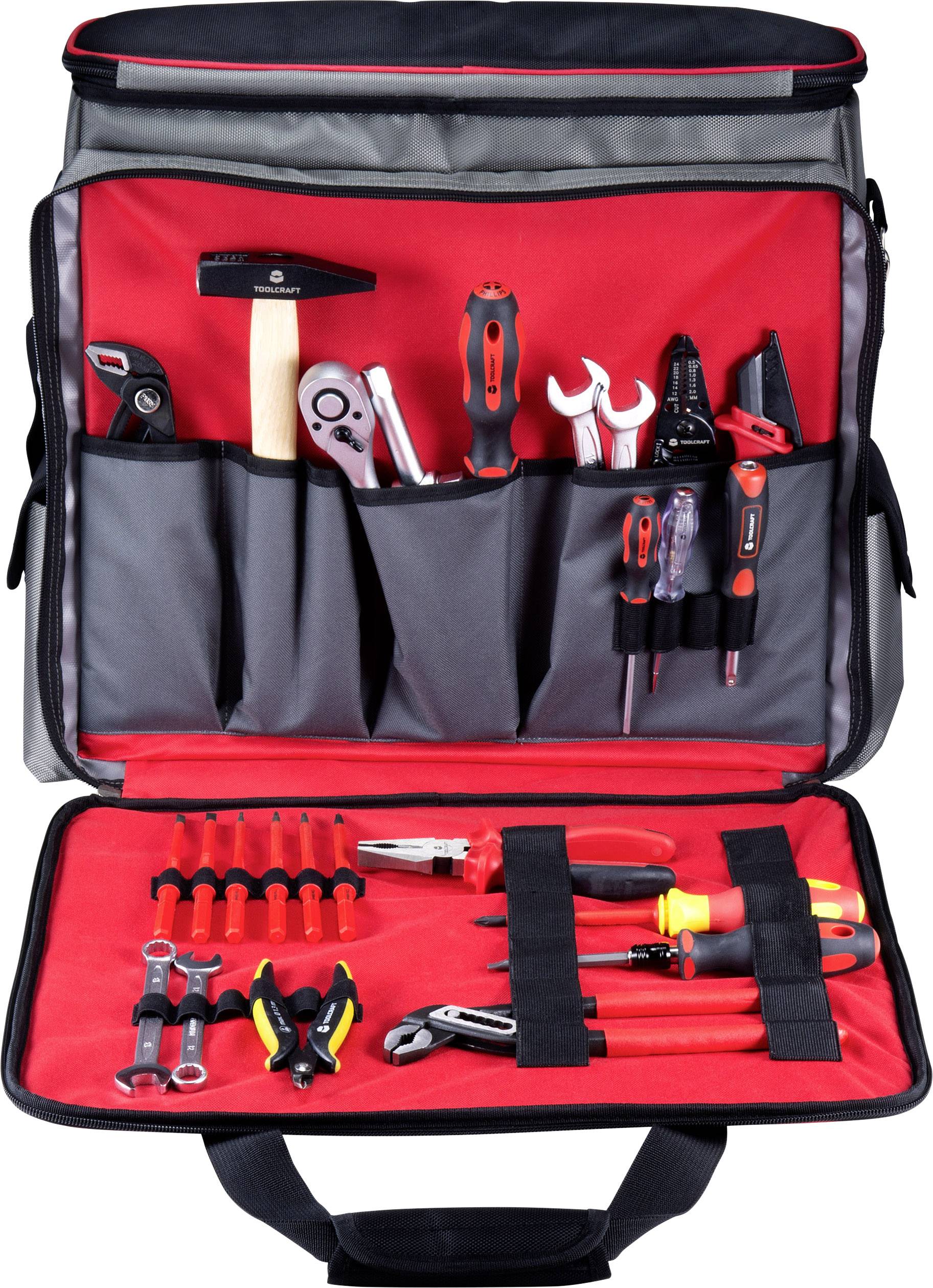 Taška na náradie s priehradkami pre kladivo, kľúče, kliešte a skrutkovače, dobre usporiadaná na červenom vnútornom povrchu.
