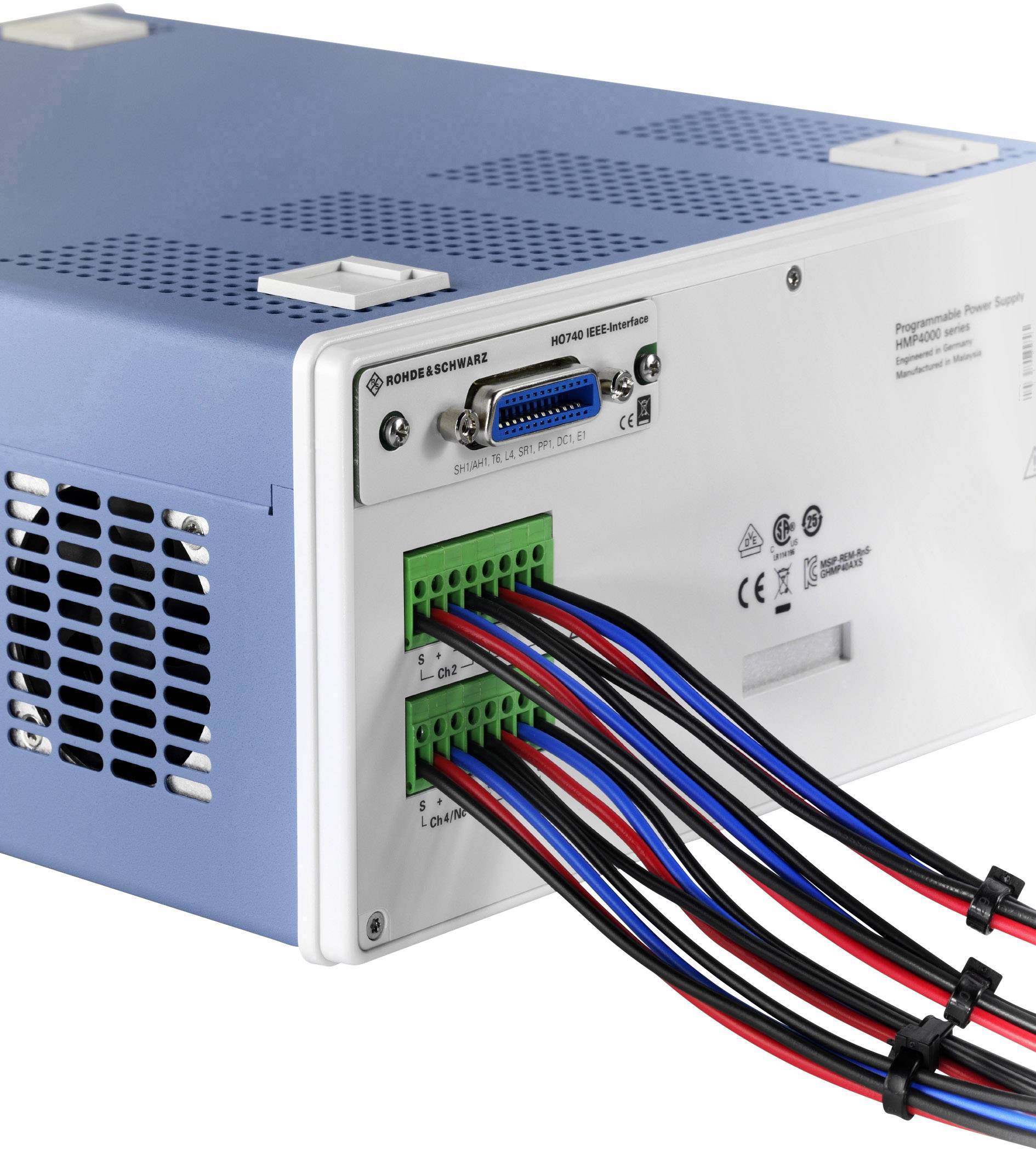 Modro-biele elektronické zariadenie s viacerými káblami trčiacimi z jeho zadnej strany. Na vrchu sa nachádza ventilátor slúžiaci na chladenie.