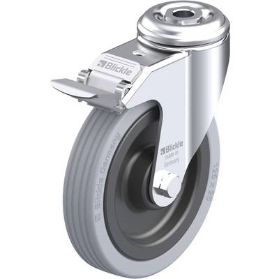 Otočné koliesko z kovu s šedým gumeným kolesom, s nápisom 'Blickle' a 'made in Germany'. Horná časť telesa je vybavená čalúneným krytom kolieska.