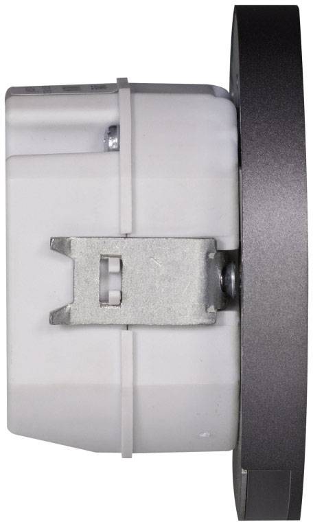 Elektrická súčiastka s kovovým upevnením, pohľad z bočnej strany. Pravá strana s tmavým krytom, ľavá strana biela so skrutkami.