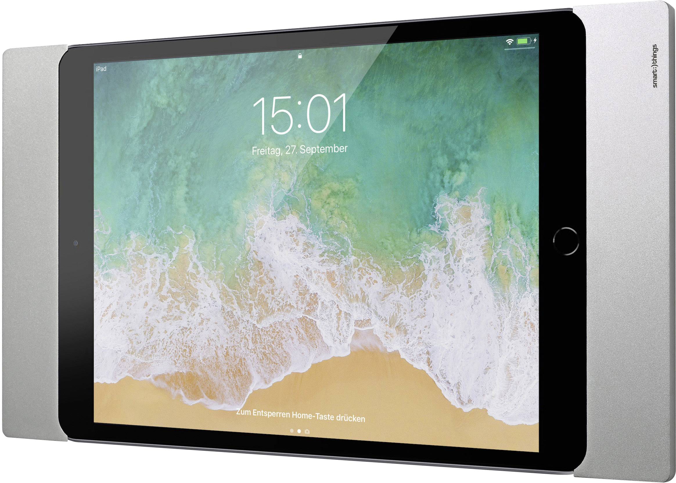 Tablet s odomknutou obrazovkou, zobrazuje čas 15:01 a dátum 'Piatok, 27. september'. Na pozadí je letecký pohľad na pláž.