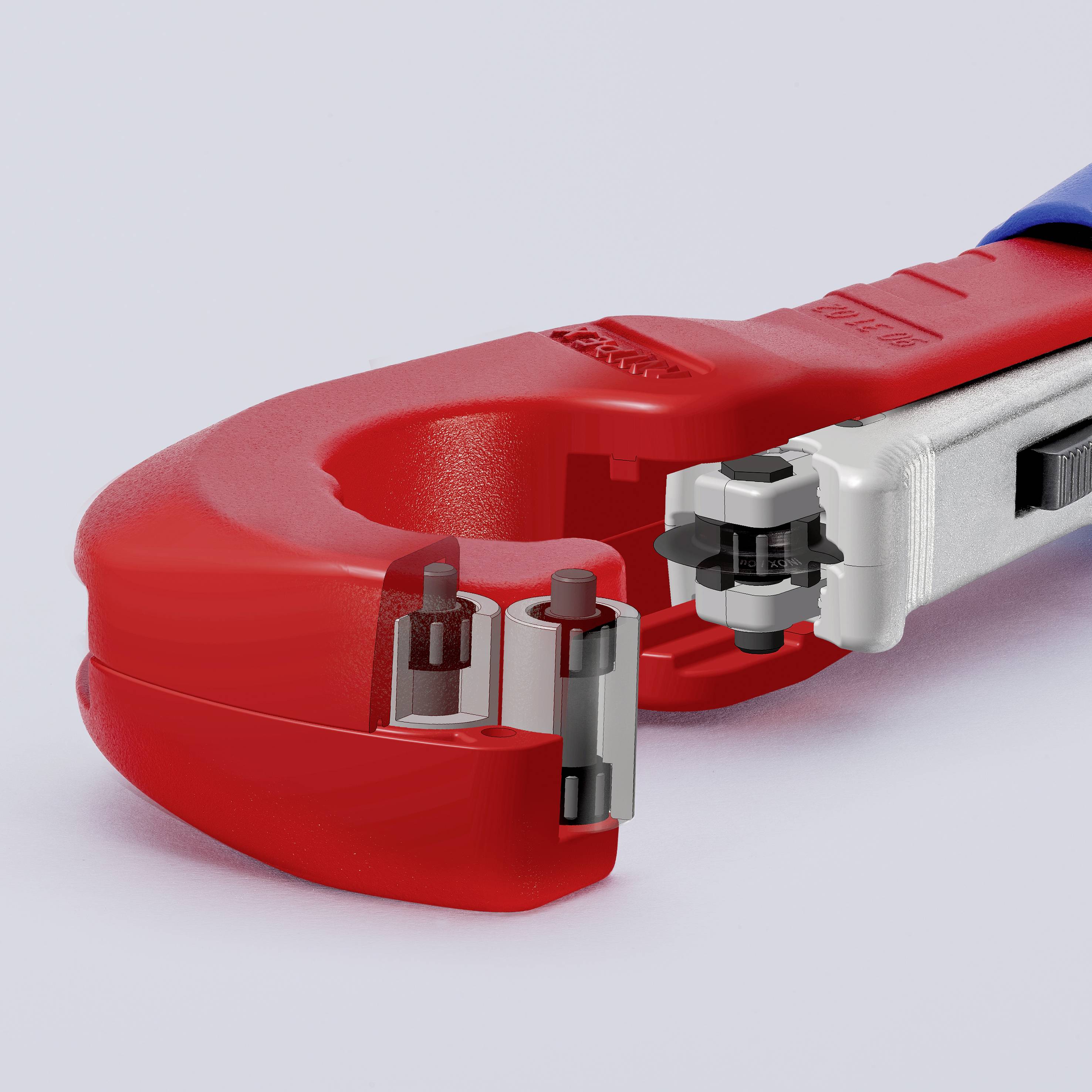 Červený rezač rúr so striebornou rukoväťou a čepeľou, ktorý práve rozrezáva kus potrubia.