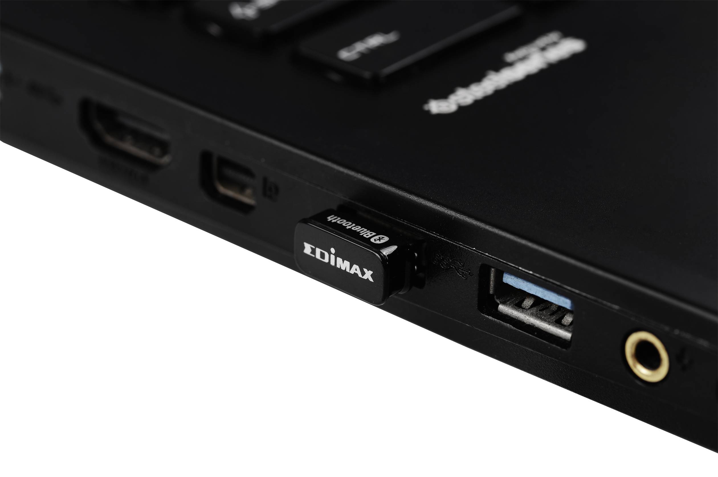 Čierny USB WLAN adaptér od Edimax je zasunutý do USB portu notebooku. Vedľa neho sú viditeľné HDMI a audio konektory.