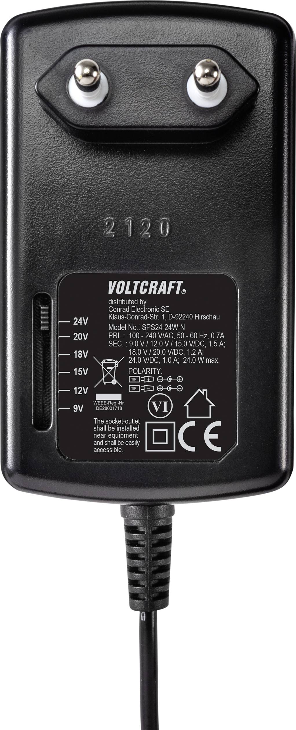 Čierne sieťové napájanie od Voltcraftu s nastaviteľným napätím od 9V do 24V, dvoma kovovými kolíkmi a štítkom s technickými údajmi.