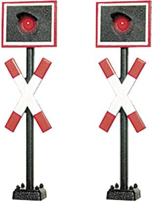 Dve červené železničné signálne svetlá s čiernym púzdrom a červenými výstražnými krížmi. Stoja vedľa seba a signalizujú zastavenie.