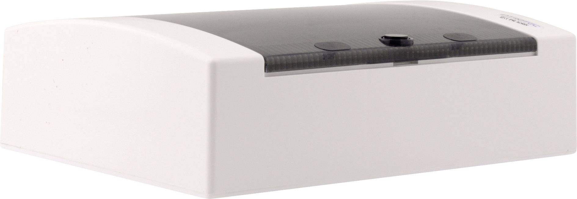 Biele elektronické zariadenie s obdĺžnikovým tvarom so zaoblenými hranami a priehľadným horným krytom, na ktorom je otočný gombík.