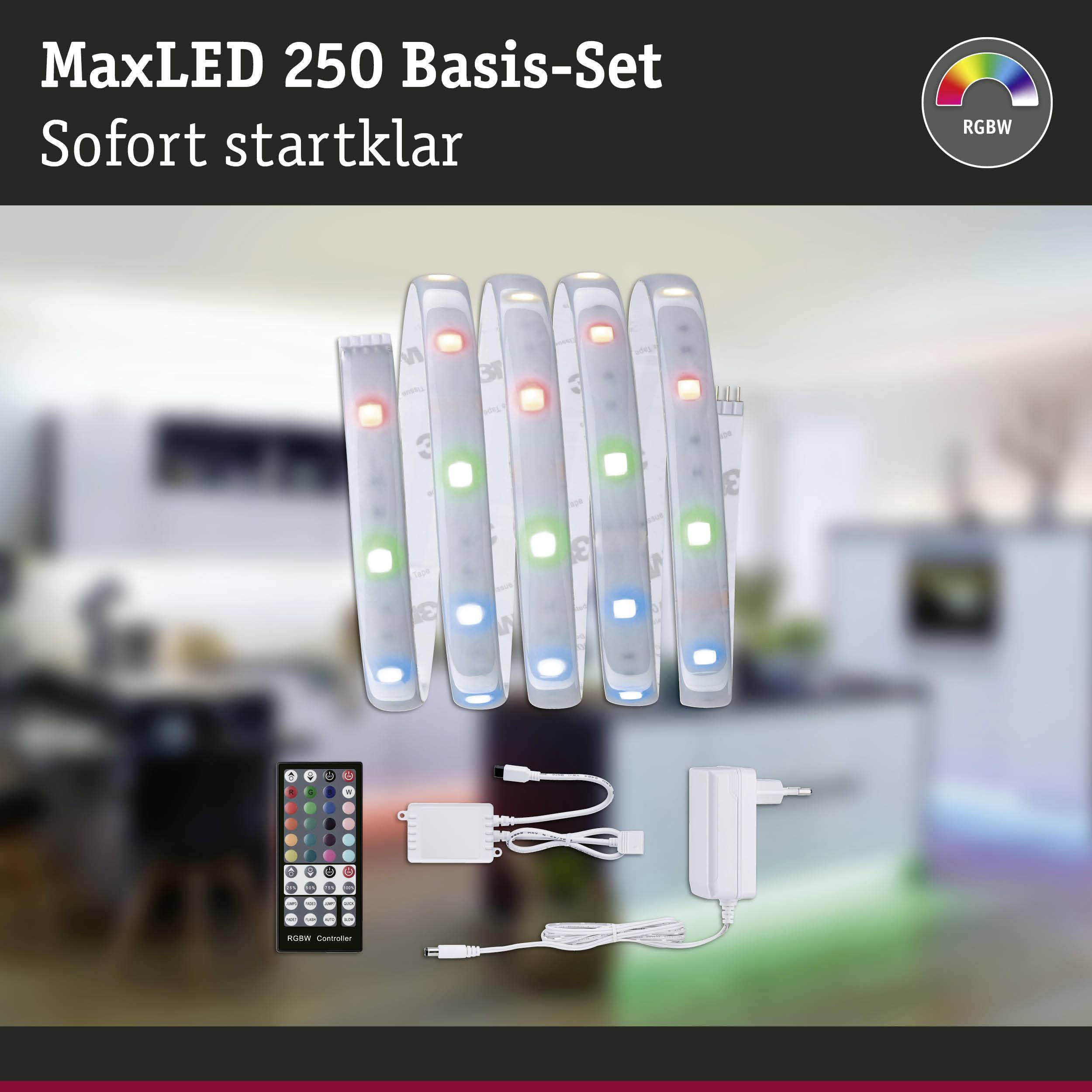MaxLED 250 základná sada s diaľkovým ovládačom a napájacím zdrojom, RGBW funkcia zmeny farieb, zobrazená v modernom obytnom priestore.