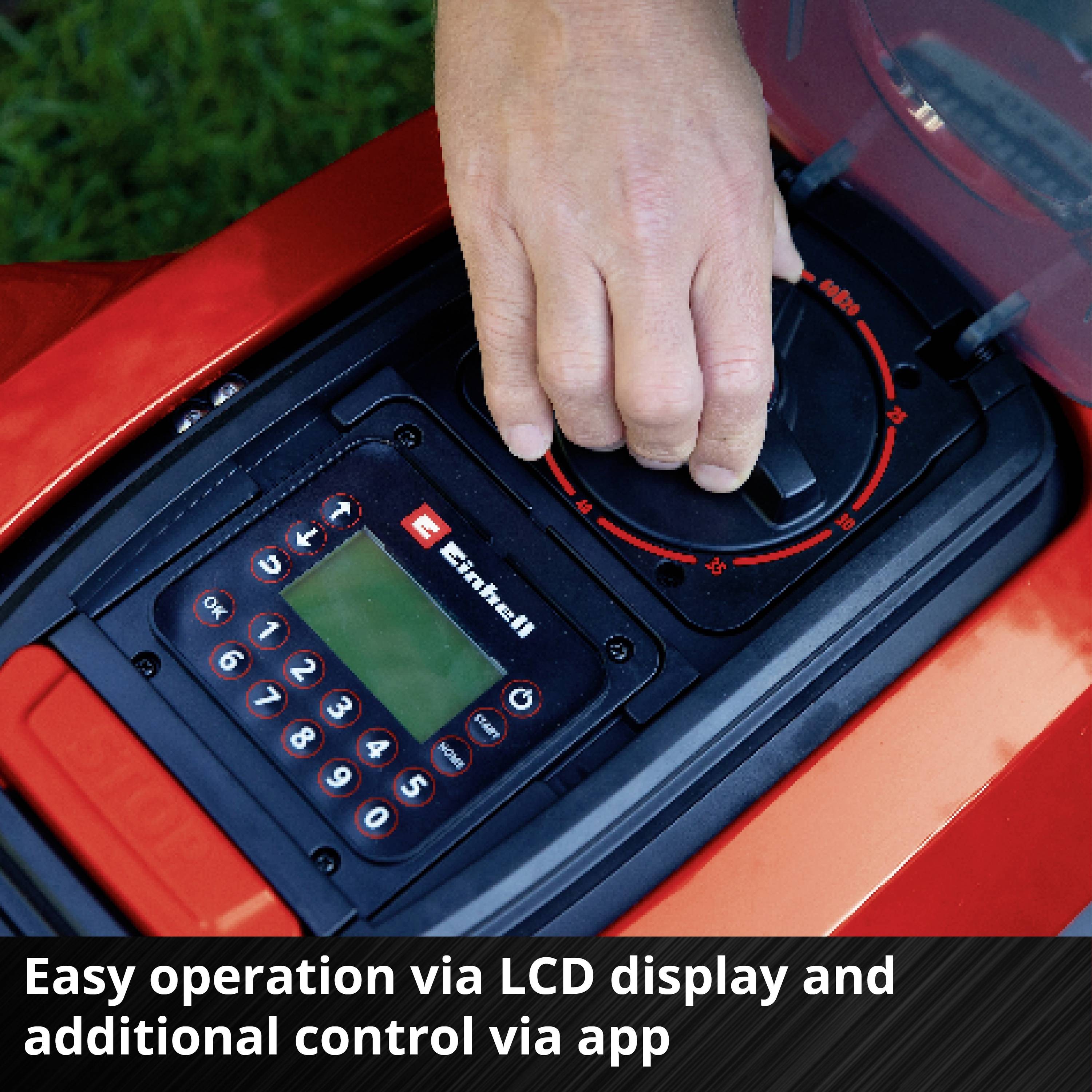 'Detailný záber ruky nastavujúcej ovládací panel s LCD displejom a tlačidlami na kosačke. Text: Jednoduché ovládanie prostredníctvom LCD displeja a ďalšie ovládanie cez aplikáciu.'