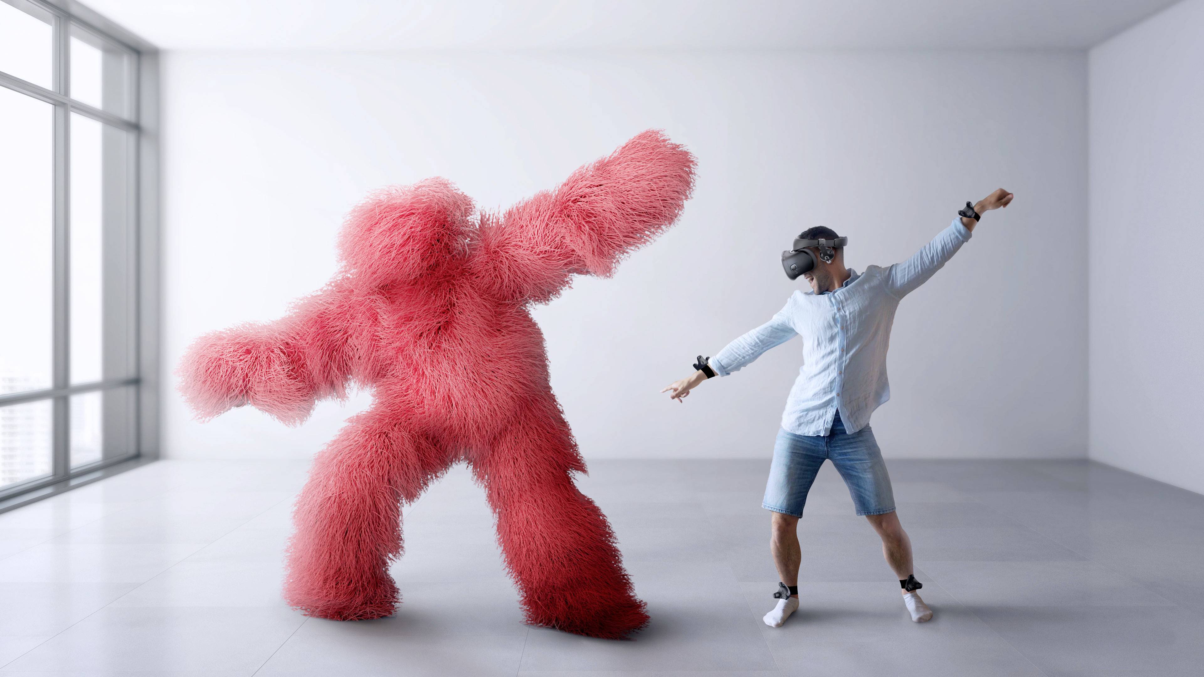 Osoba nosí VR headset a tancuje vedľa veľkej, červenej, chĺpkatej figúry v modernej, prázdnej miestnosti.