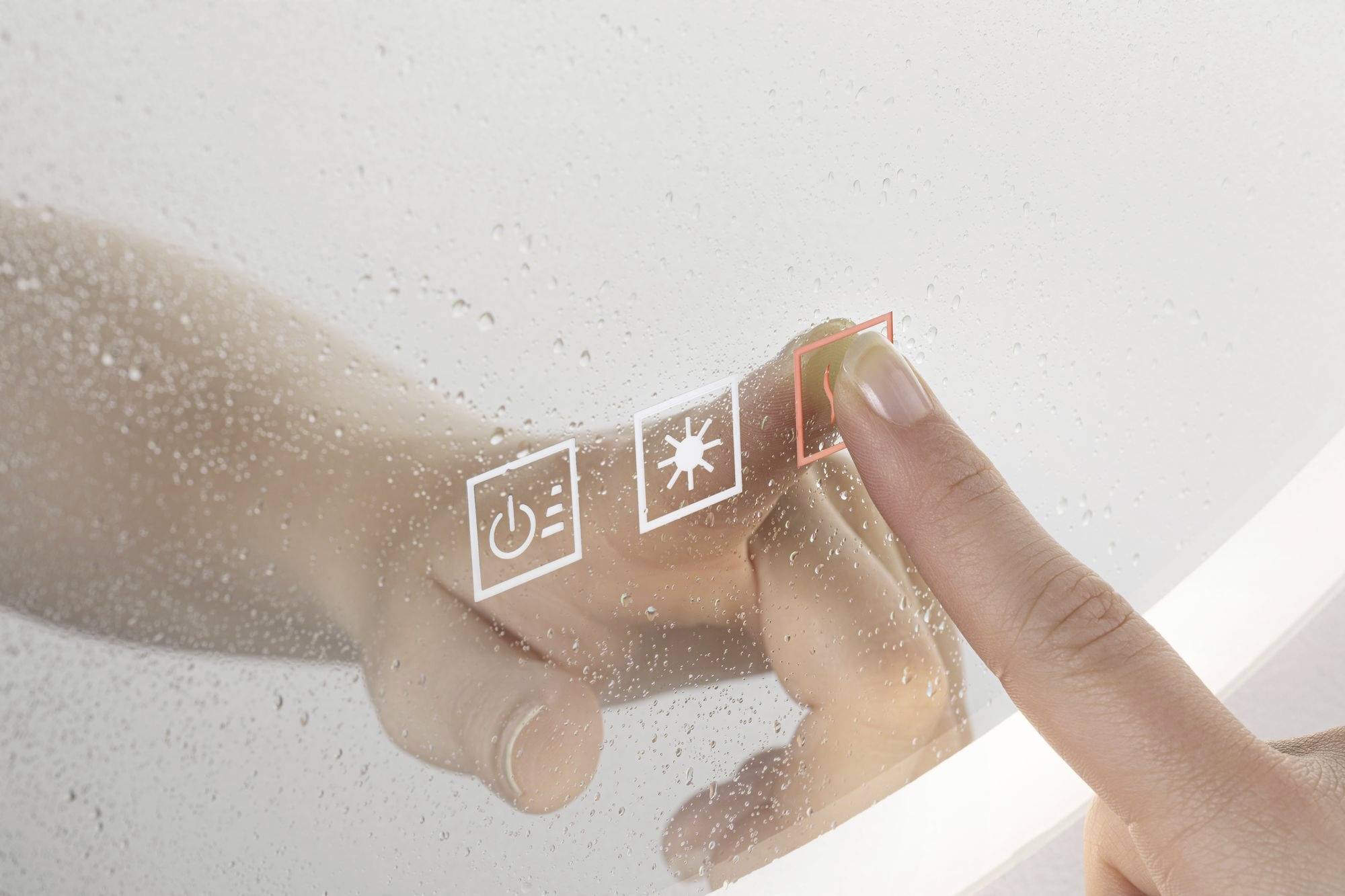 Prst sa dotýka obrazovky s tromi symbolmi: tlačidlo zapnutia/vypnutia, slnko a prázdny obdĺžnik, pravdepodobne ovládacie prvky.