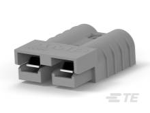 Šedý dvojpólový elektrický konektor obdĺžnikového tvaru s rebrovanými stranami pre bezpečnéuchytenie.